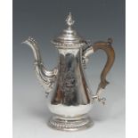 An early George III silver baluster coffee pot, conical bud finial, hinged ogee cover, double-scroll