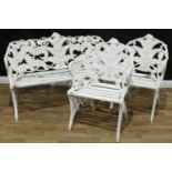 A Coalbrookdale style 'blackberry and fern' pattern three piece garden suite, comprising a bench and