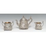 A Victorian silver composed three piece pear shaped Teniers bachelor's tea service, comprising