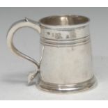 A Queen Anne Britannia silver spreading cylindrical mug, reeded quarter girdle, skirted base, 9.