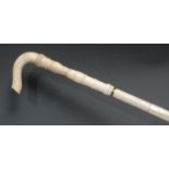 A 19th century whalebone and marine ivory walking stick, crook-shaped handle, turned multi-section