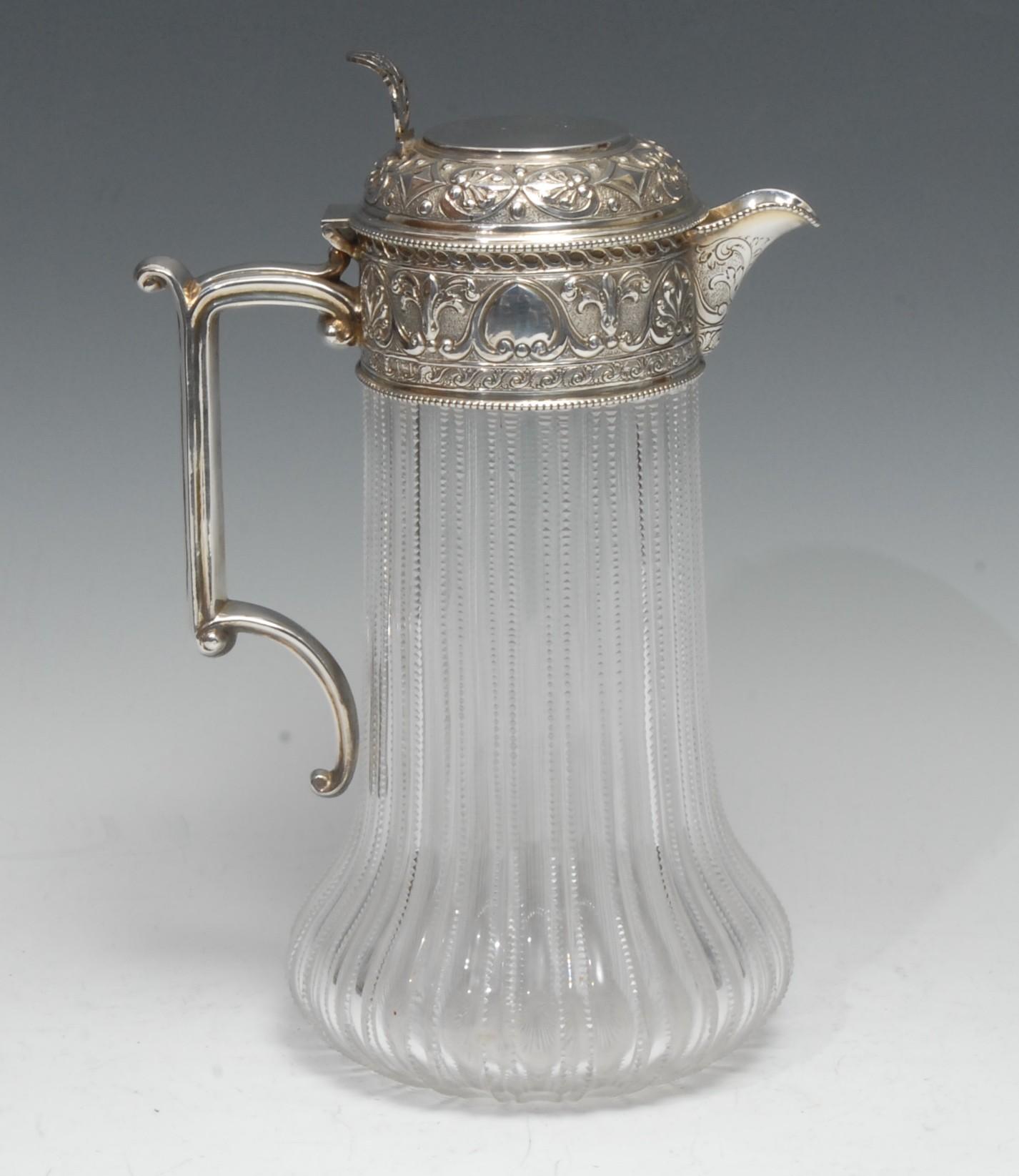 A large Victorian silver mounted cut-glass claret jug, hinged cover with pierced thumbpiece,