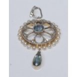 A diamond, seed pearl and pale blue stone possibly aquamarine pendant, open cast mount with