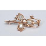 A diamond and pearl brooch, three petal body inset with three irregular creamy white pearls and