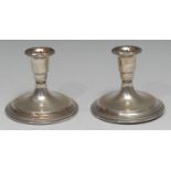 A pair of Danish silver candlesticks, of squat proportions, bell shaped sconces, domed bases, rope-