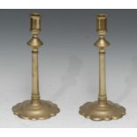 A pair of George II brass candlesticks, spreading high-knopped cylindrical pillars, petal bases,