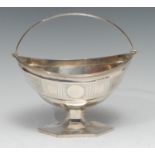 A George III silver navette shaped pedestal sugar basket, bright-cut engraved and outlined