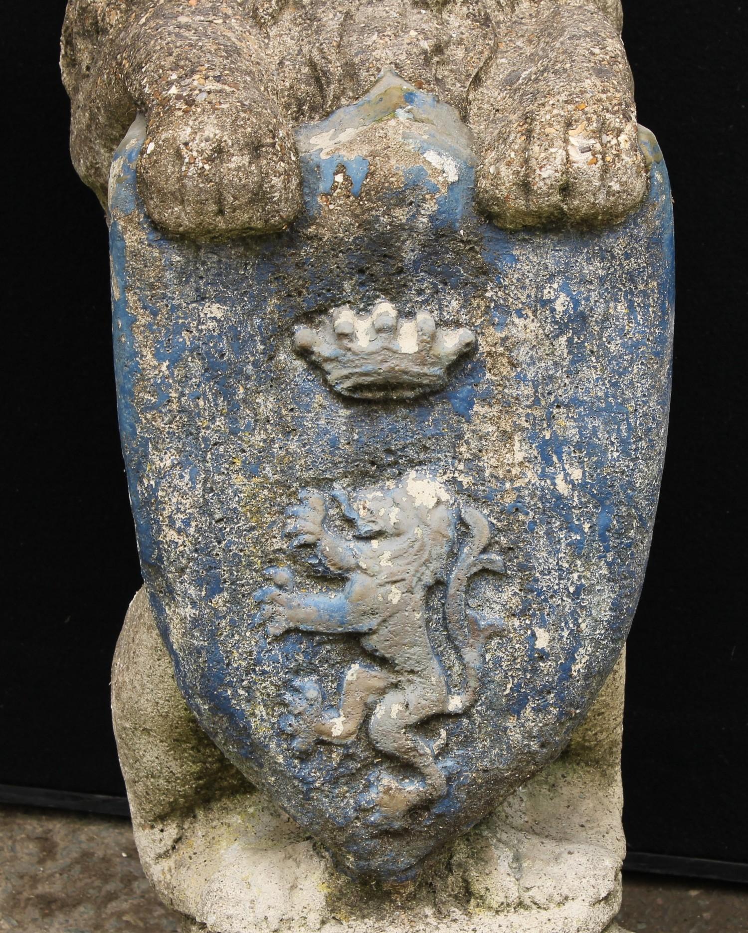 A pair of reconstituted stone heraldic lions, each grasping a shield, stepped bases, 74cm high, 26cm - Bild 3 aus 3