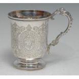 A Victorian silver bell shaped pedestal mug, engraved with flowers, foliage and strapwork, leafy