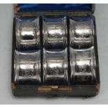 A set of six Victorian E.P.N.S napkin rings, each numbered and engraved with C-scrolls, leaves and