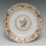 A Derby shaped circular dish, painted by George Complin, with ripe fruit and foliage within gilt