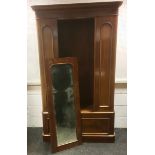 A Victorian mahogany single door wardrobe, arched top mirrored door, twin side railed interior above