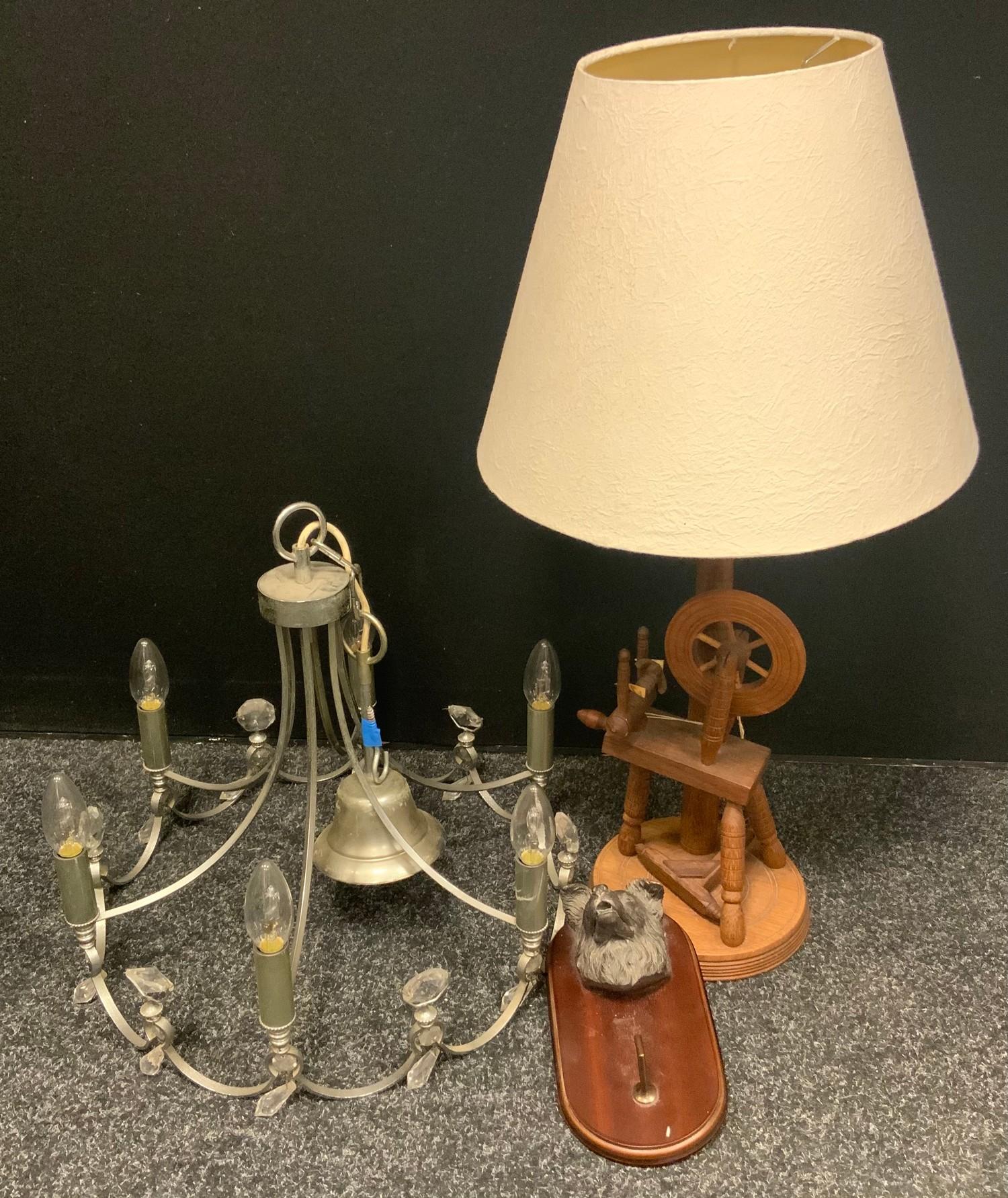 A novelty table lamp as a spinning wheel; a metal and cut glass six light electrolier; a bronzed dog
