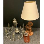 A novelty table lamp as a spinning wheel; a metal and cut glass six light electrolier; a bronzed dog