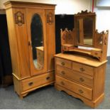An Edwardian satinwood wardrobe, outswept cornice, oval mirrored central door, deep drawer to