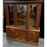 A 19th century style oak display cabinet three glazed doors enclosing adjustable shelving to top,