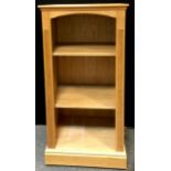 An oak effect bookcase, adjustable shelving, castors. 140cm high x 70cm wide x 56cm deep.