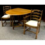 An Ercol style gate leg table, oval top; a conforming carver and dining chair; two other oak