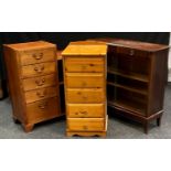 A teak bookcase cabinet, five fall front faux drawers, adjacent shelving; a mahogany bookcase, two