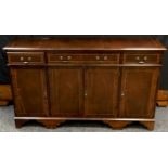 A reproduction mahogany sideboard, moulded top, one long drawer flanked by two short drawers over