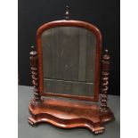 A Victorian mahogany dressing mirror, arched mirror, turned finials to barley twist uprights,
