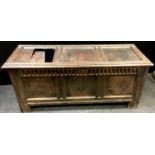 An 18th century oak blanket box, three panelled top, nulled frieze, stile feet. 60cm high x 147cm