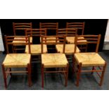A set of eight contemporary raffia seated kitchen dining chairs.