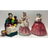 A Royal Doulton Figure Genevieve, Hn 1962; another The Old Balloon Seller, Hn 1315; another Wedgwood
