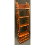 A mahogany bookcase of slender proportions, four shelves over two drawers, pierced sides, 110cm