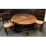 A set of four raffia seated spindle back Lancashire style dining chairs; an oak gate leg table, oval