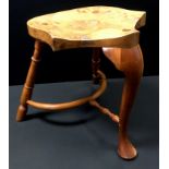 A Stewart Linford burr elm and yew wood stool, shaped saddle seat, cabriole forelegs, turned rear