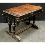 An oak Gothic revival desk, canted rectangular top, carved border, carved front drawer to frieze,