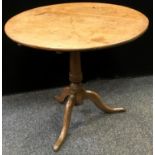 A George III oak tilt-top occasional table, circular top, canon barrel column, cabriole legs. 72.5cm