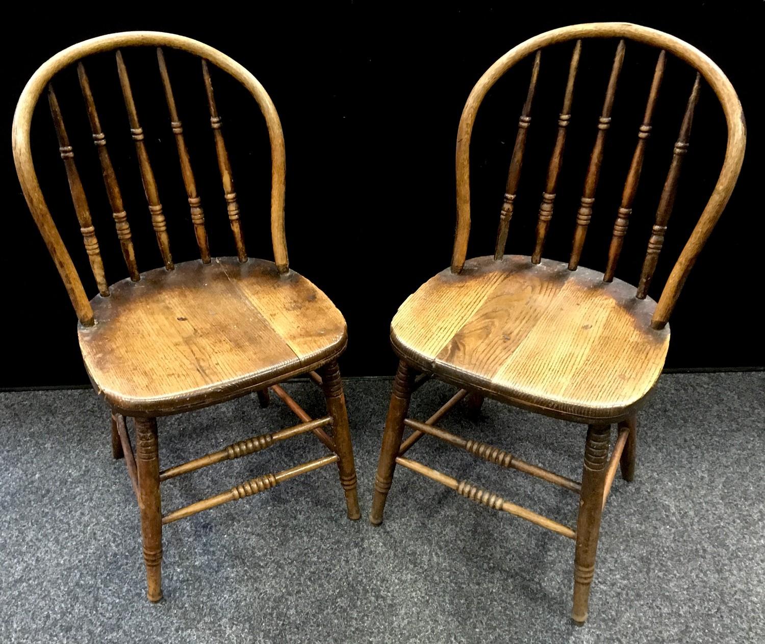 A pair of bentwood hoop back dining chairs, spindle back, oak saddle seat, turned legs and