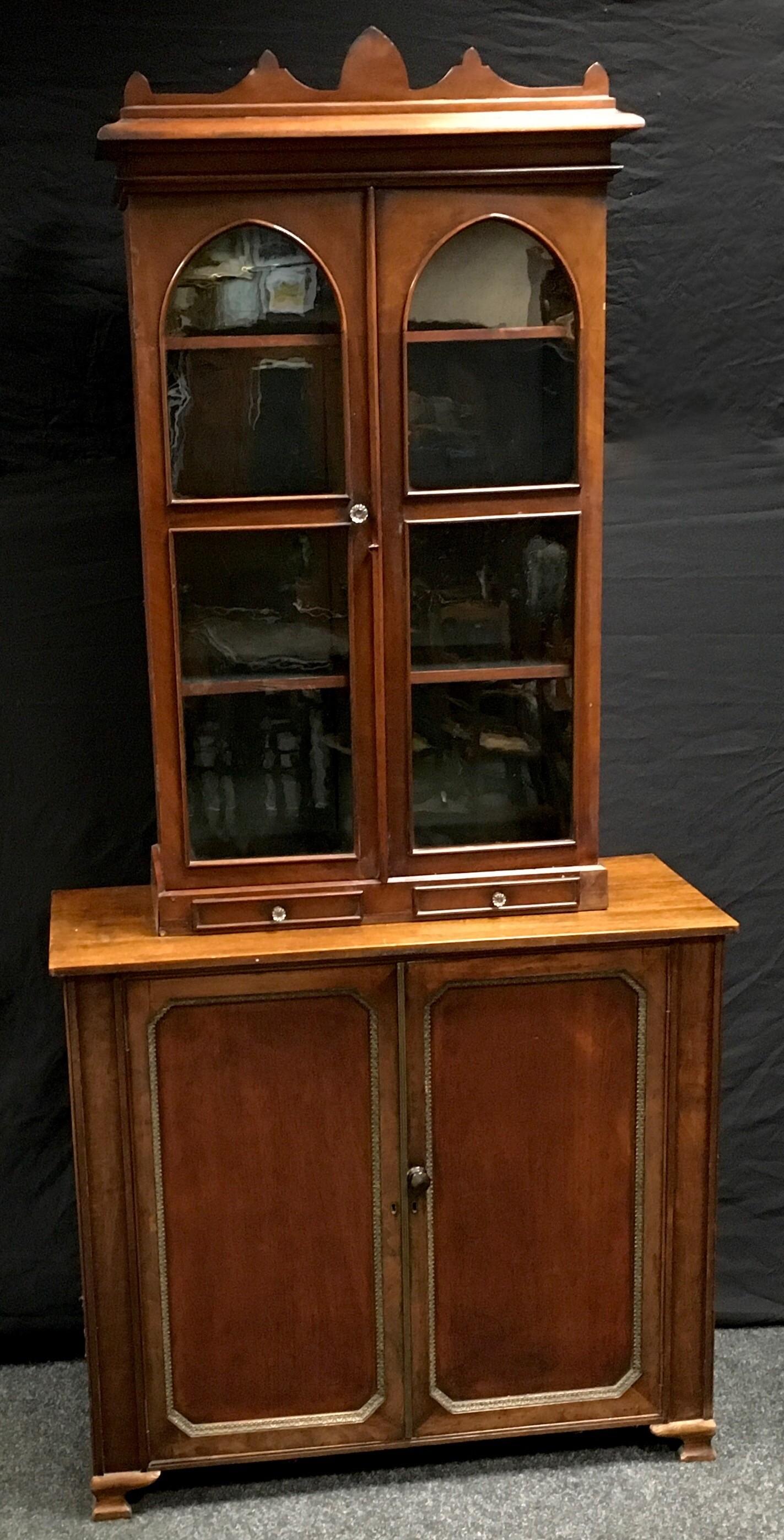 A Victorian mahogany and stained pine bookcase top, shaped pediment, two arched glazed doors over