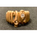 A gold coloured metal wire work snake ring, diamond set head, unmarked, tests as approx 20ct gold,