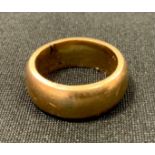 A gold coloured metal wedding band, unmarked, tests as 10ct gold, 15.2g