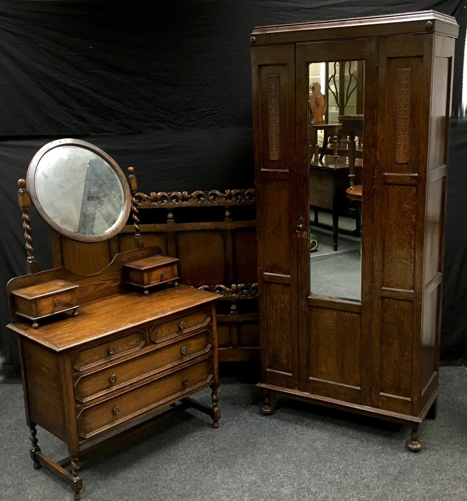 A 1930/40?s oak wardrobe, central mirrored door; an oak three drawer dressing chest; an oak double