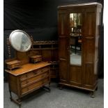 A 1930/40?s oak wardrobe, central mirrored door; an oak three drawer dressing chest; an oak double