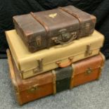 An early 20th century travelling trunk; other suitcases (3)