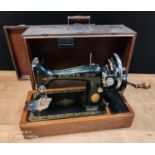 A vintage Singer hand operated sewing machine , cased