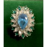 An Art Deco style floral base metal dress ring, set with an arrangement of clear and blue and