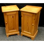 A pair of pine single door bedside cabinets, rounded tops, panel doors, 71.5cm high, 38cm wide