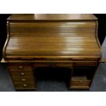 An oak roll top bureau, tambour top enclosing fitted interior, single drawer over kneehole flanked