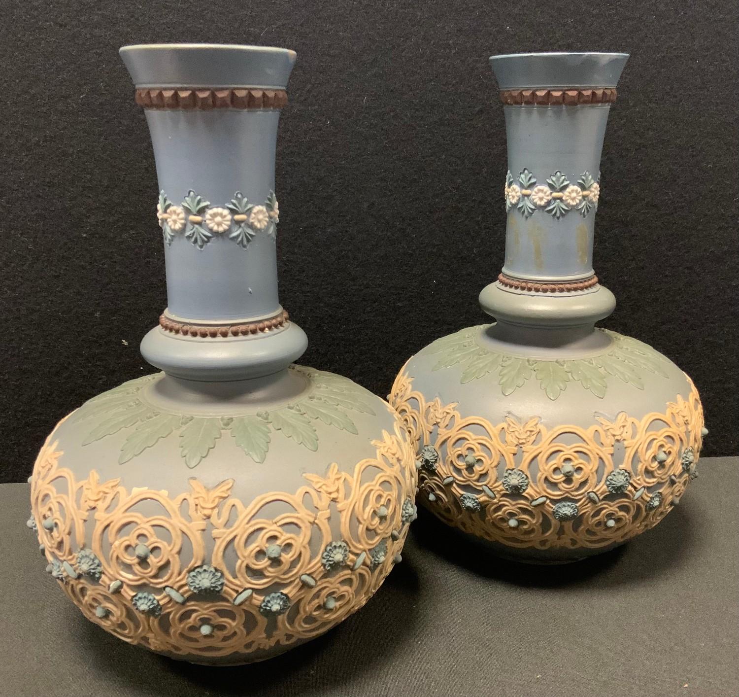 A pair of Doulton Lambeth Siliconware vases, molded with a lattice and floral band, impressed marks,