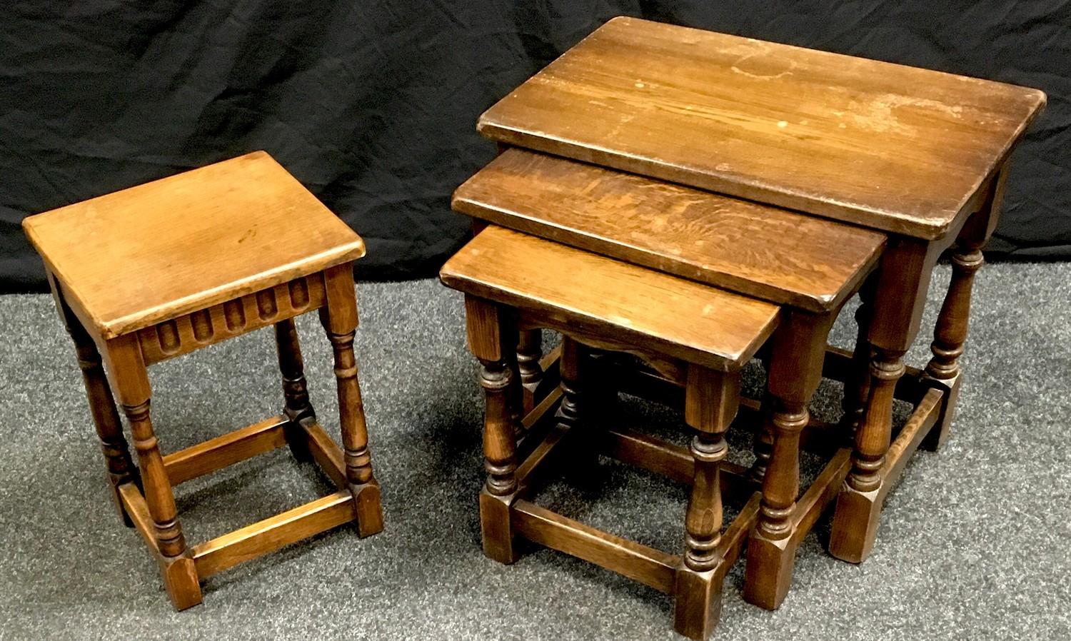 A Jaycee oak nest of three tables; a Priory style oak occasional table of small proportions. (2)