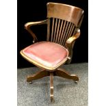 An early 20th century oak office swivel chair.