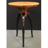 A contemporary designer occasional table, circular top, stepped circular socle , three slender