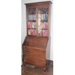 An early 20th century mahogany bureau bookcase, moulded cornice, above astragal glazed doors, the