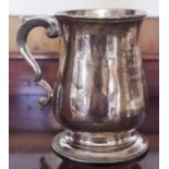 An early George III silver bell shaped mug, capped double scroll handle, skirted base, 12.5cm